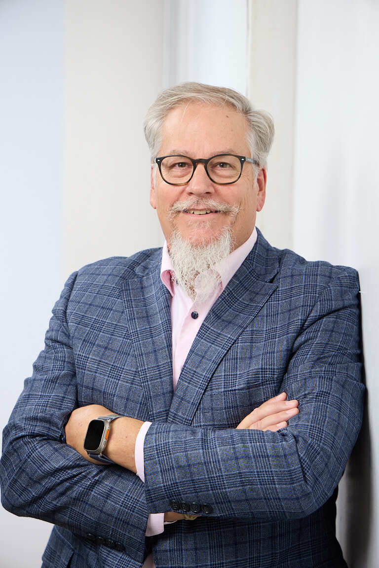 Ed Marsh, industrial revenue growth consultant, arms crossed in a navy blazer